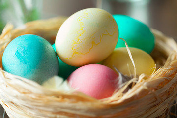 Easter background. colorful eggs in a nest of straw