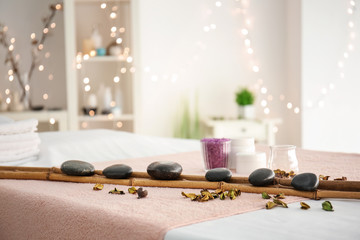 Massage stones with bamboo on table in spa salon