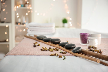 Massage stones with bamboo on table in spa salon
