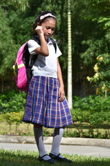 Depressed Female Student Wearing School Uniform With Notebooks