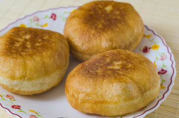 Traditional Russian meat pies belyashi on a plate.