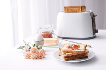 Plate with tasty toasts for breakfast on table