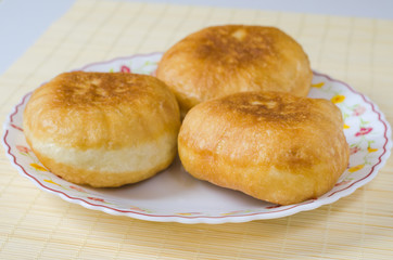 Traditional Russian meat pies belyashi on a plate.