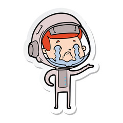 Obraz premium sticker of a cartoon crying astronaut