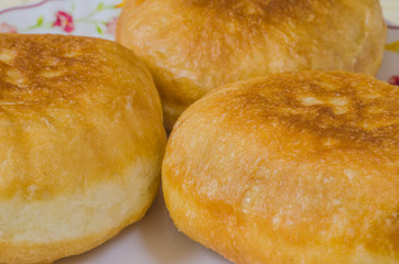 Traditional Russian meat pies belyashi on a plate.