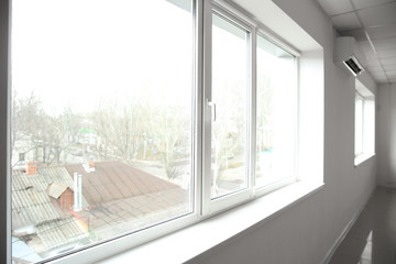 Big modern metal-plastic windows in room