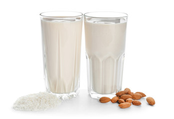 Glasses of different vegan milk on white background