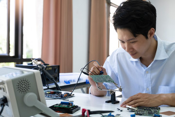 Technician checks the electronic device.