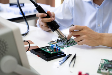 Technician checks the electronic device.
