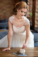 The bride puts  money in moneybox