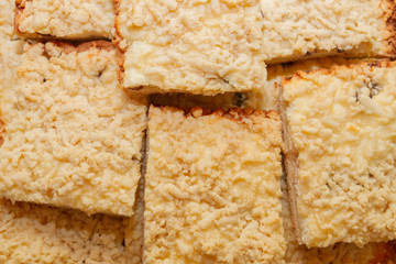 Freshly baked sand cake cut into pieces lie on top of each other