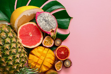 Assortment of exotic fruits on color background