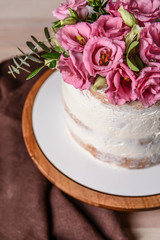 Sweet cake with floral decor on table, closeup