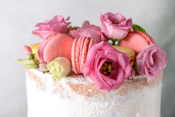 Sweet cake with floral decor on light background