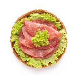 Sandwich with salami sausage on white background.