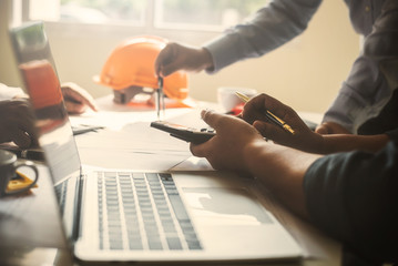 Meeting architect teamwork construction plan people with blueprints.