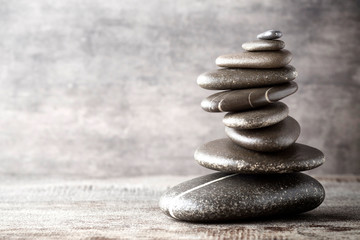 Balancing stones on the grey background.