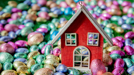 Chocolate Easter eggs and toy house on it