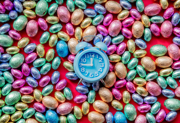 color Chocolate Easter eggs and alarm clock on it