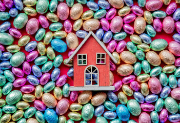 Chocolate Easter eggs and toy house on it