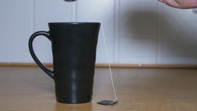 Putting sugar in tea, stiring with a spoon