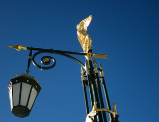 old street lamp on a background of blue sky