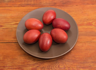 Easter eggs on the brown dish on a rustic table
