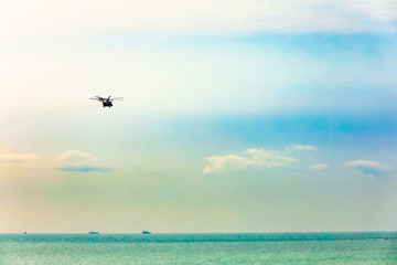 helicopter flying over the ocean