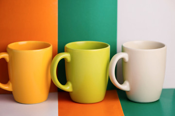 multi-colored ceramic cup on a colorful background