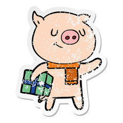 distressed sticker of a happy cartoon pig with christmas present
