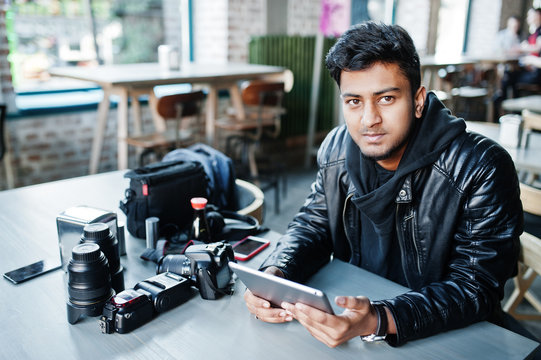 Smart Young Asian Man Photographer Working With Tablet During Sitting At Cafe.