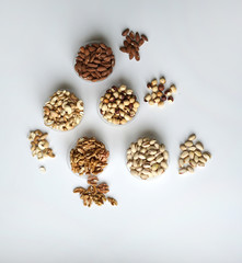 Fototapeta na wymiar Healthy food. Nuts mix assortment on stone table top view. Collection of different legumes for background image close up nuts, pistachios, almond, cashew nuts, peanut, walnut. image
