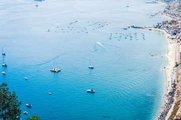 Sea view with sailboat, motor boat from Taormina, Sicily, Italy.