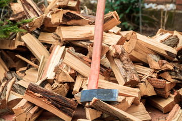 cleaver on the bunch of chopped firewoods