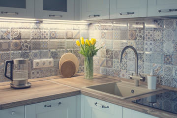 White kitchen with patchwork tile. - obrazy, fototapety, plakaty