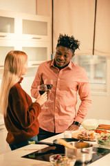 Young couple having pleasant talk and drinking wine