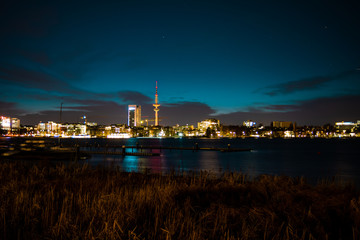 Night view of Hamburg's cityscape across the Alster river