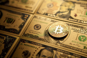 Bitcoin golden coin cryptocurrency on golden US dollar.