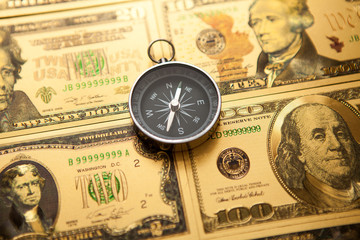 Dollars and compass. Concept on a financial theme.