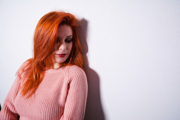 portrait of a red-haired girl at the wall