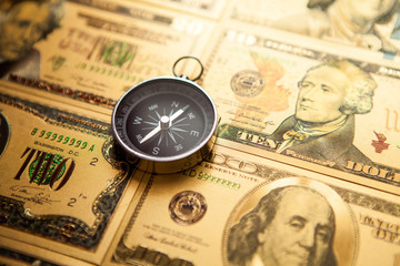 Dollars and compass. Concept on a financial theme.
