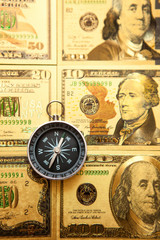 Fototapeta na wymiar Dollars and compass. Concept on a financial theme.
