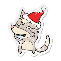 distressed sticker cartoon of a hungry wolf wearing santa hat
