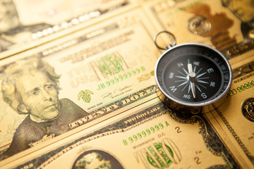 Dollars and compass. Concept on a financial theme.