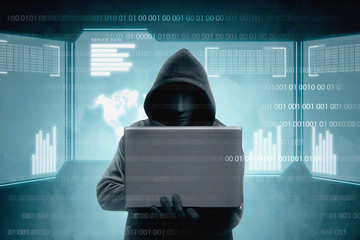 Hacker in black hoodie holding laptop and virtual screen display the server data, binary code, bar graph and world map