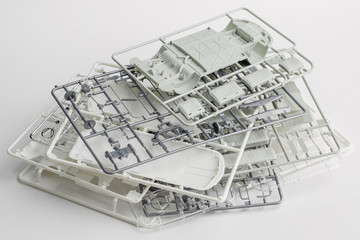 kit for assembling gray plastic car model on white background