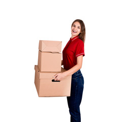 Pretty young woman loves her job. Delivery girl is holding a heap of boxes isolated on white background
