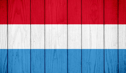 Flag of Luxembourg on wooden background