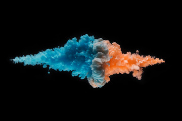 Coloured acrylic ink mixing in water on black