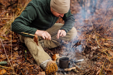 quail on the stick grilled in the fire. delicious forest picnic. bushcraft concept
